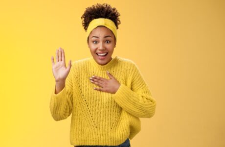 Girl in yellow background greeting