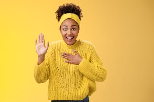 Girl in yellow background greeting