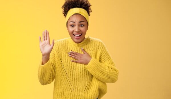 Girl in yellow background greeting